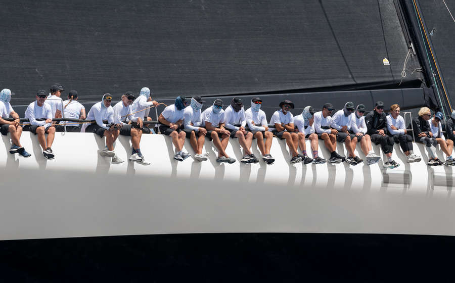 Racing crew on the rail of a maxi yacht, BVI regatta